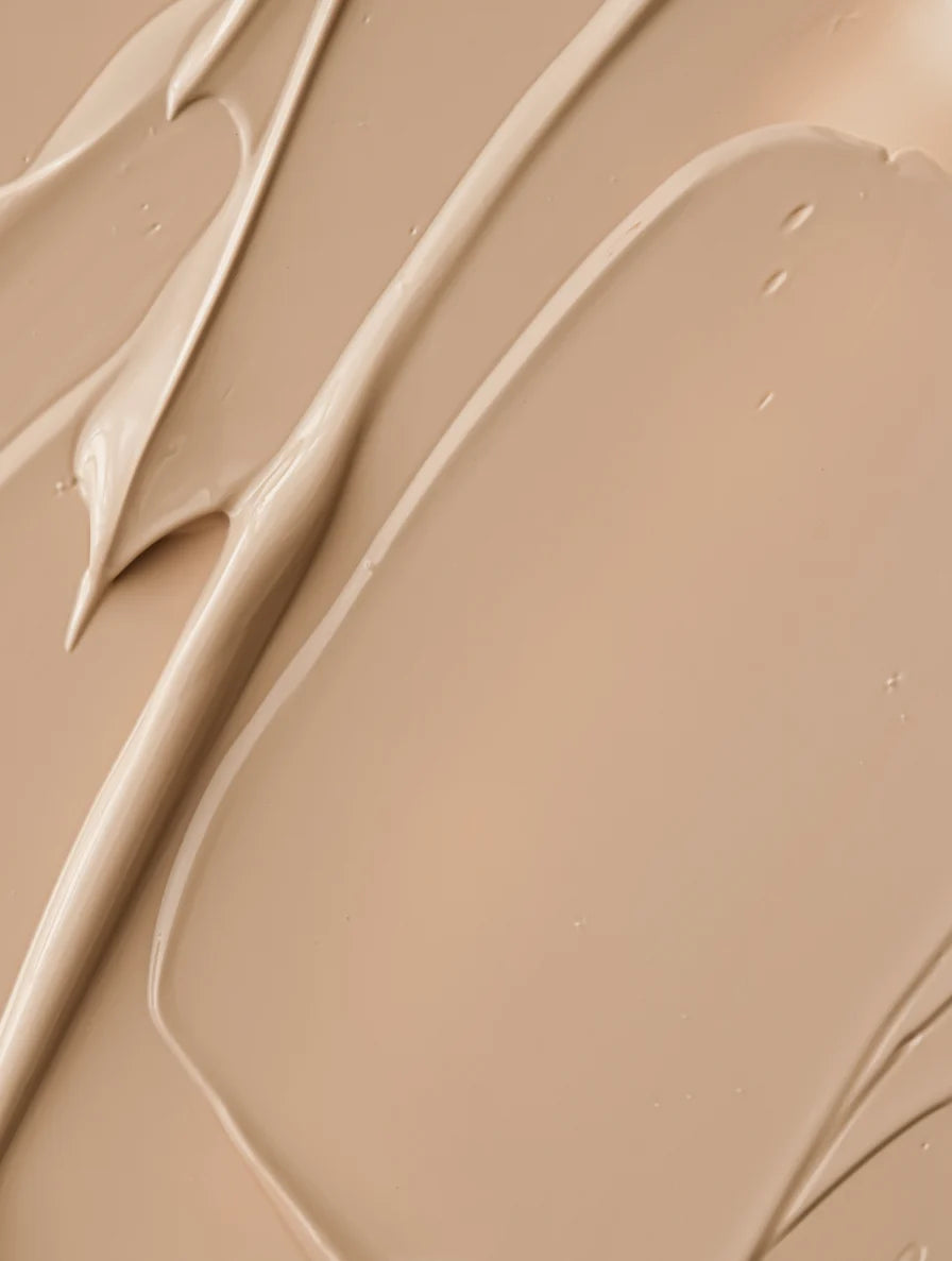 Close-up of beige cream texture with natural light